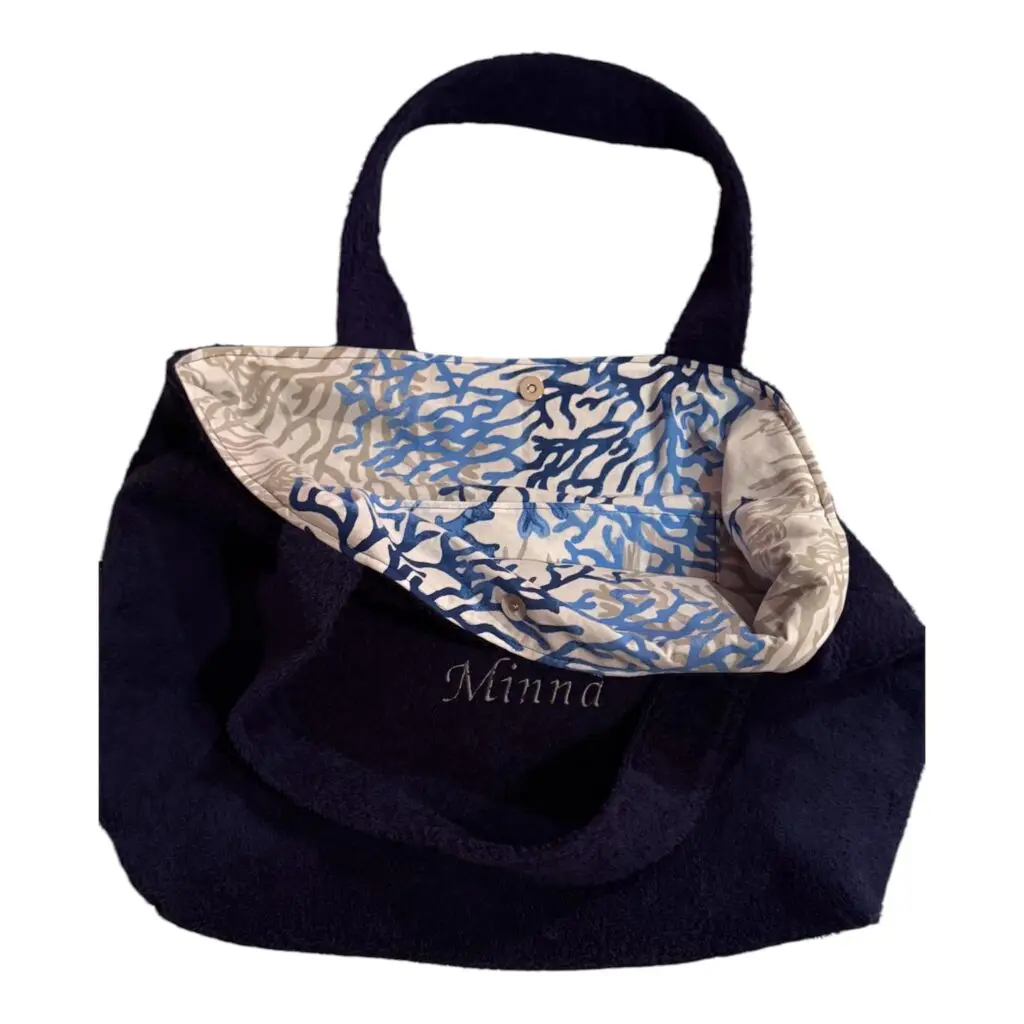 Navy tote bag with a blue-and-beige patterned scarf wrapped around the handles.
